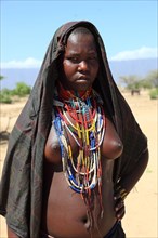 South Ethiopia, in a village of the Arbore or Erbore people at Lake Stefano, young woman wearing