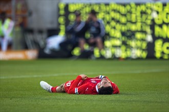 Football match, Kevin SESSA 1. FC Heidenheim lying exhausted on the ground with his head up and his