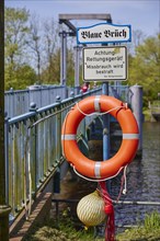 Lifebuoy with sign Abuse will be punished and information board Blaue Brueck in Friedrichstadt,