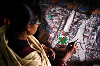 Woman taking drawing lessons in a drawing school, learning the Madhubani style of painting, Bihar,