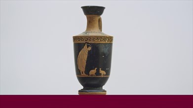 A boy watches two partridges, Antique Greek vase with a black figure and red decorations on a beige