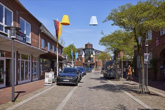 Main street, a shopping street, in the town centre of Niebuell, Nordfriesland district,