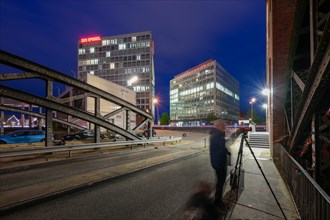 Head office of the news magazine Der Spiegel, in front of it a shadowy photographer on a bridge,