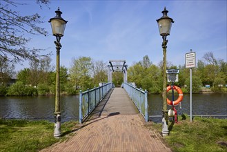 Blue bascule bridge over the Westersielzug with lanterns in Friedrichstadt, Nordfriesland district,