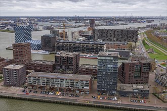 Modern residential complexes and buildings line the riverbank, shaping the urban architecture under