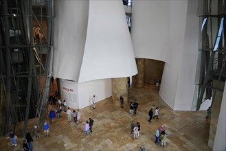 Guggenheim Museum, Bilbao, Basque Country, Spain, Europe, People visit the interior of a modern