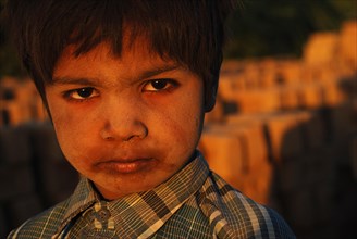 Boy working in a brick kiln, Kutch district, Gujarat, India, Asia