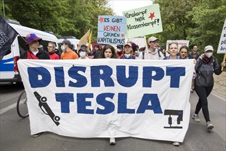 Participants with banner Disrupt Tesla and signs There is no green capitalism and climate struggle