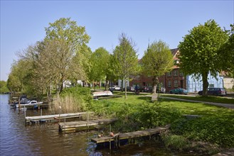 Jetties for pleasure craft on the banks of the Westersielzug in Friedrichstadt, Nordfriesland