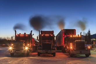 Three American trucks with engine running, truck, twilight, winter, Coldfoot, Alaska, USA, North