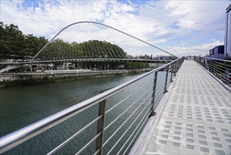 Pedestrian bridge Zubizuri, White Bridge, Bilbao, Promenade along a river with futuristic bridge,