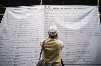 Barpeta, India. 6 May 2024. Polling officials check their name allocated polling station name, on