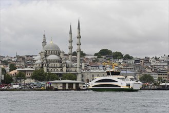View of a mosque and a passing boat on the water in Istanbul on a cloudy day, Istanbul, Istanbul