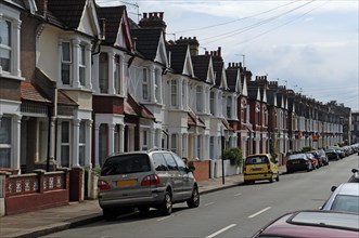 Typical English terraced houses with telephone lines, Valnay Street, Tooting Broadway, London,