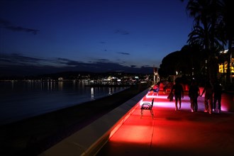 Cannes, France, 13 May 2024: People stroll along the Boulevard de la Croisette on the eve of the