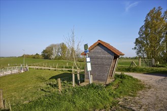 Rural bus stop with wooden bus shelter in Tetenbuell, Nordfriesland district, Schleswig-Holstein,