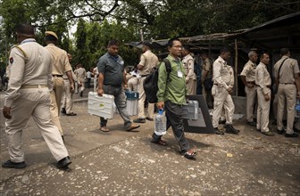 Barpeta, India. 6 May 2024. Polling officials carries Electronic Voting Machines (EVMs) and Voter