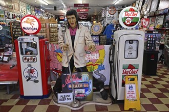 Elvis between historic petrol pumps in a souvenir shop, Williams, Arizona
