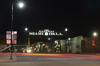 Night shot of illuminated main road with neon lettering above the road, Route 66, Miami, Oklahoma