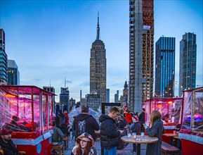 Open-air terrace on the 20th floor: 230 Fifth Rooftop Bar NYC in front of the Empire State