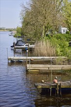 Jetties for pleasure craft on the Westersielzug with the Treene in the background in