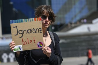 Participant in the silent protest for the hunger strikers. Her placard reads: Ignorance kills .