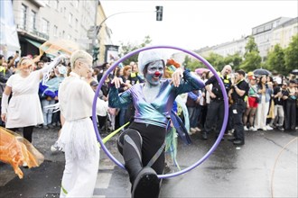 Dancer of the CABUWAZI children's and youth circus with hoops at the street parade of the 26th