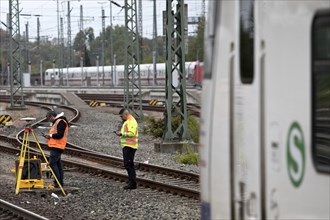 Railway worker surveying on the tracks with S-Bahn, Hanover-Nordstadt station, Hanover, Lower