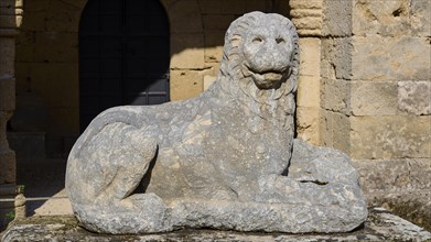 Stone lion statue sits majestically in front of a medieval fortress, outdoor area, Archaeological