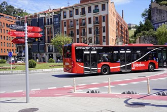 On the road in Bilbao, Province of Bizkaia, Basque Country, Spain, Europe, Red bus on a street in