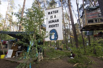 Central square and banner Water is a human right! (Water is a human right!) in the occupied forest