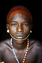 Portrait of a teenage boy from the Samburu tribe, Kenya. He has completed his initiation rite and