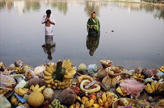 Hindu couple celebrating the Chhath puja festival by worshipping the sun god Surya, Janakpur,