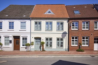 Residential building with pointed roof against a deep blue sky in Toenning, Nordfriesland district,