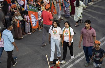 Bharatiya Janata Party (BJP) supporters arrives to to see a roadshow of Union Home minister Amit