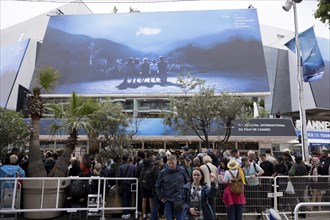 Cannes, France, 14 May 2024: Guests in front of the poster at the opening of the 77th Cannes