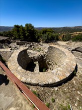 View of Kouloures Ring in earth embedded large walled round storage container in area of Old Palace