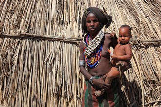South Ethiopia, in a village of the Arbore or Erbore people at Lake Stefano, young woman with baby