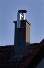 Retrofitted chimney on roof, with dust separator, electrostatic filtering of soot particles from