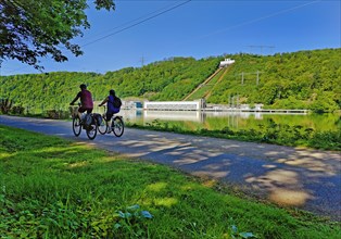 Cyclist at the Hengsteysee in Hagen in front of the Koepchenwerk in Herdecke, North
