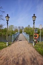 Blue bascule bridge over the Westersielzug with lanterns in Friedrichstadt, Nordfriesland district,