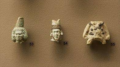 Eastern Greek or Rhodian workshop, Three ancient stone masks in detail view on a wall, interiors,
