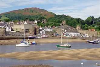 Small harbour at low tide with sailing ships, parts of an old fortification, Conwy, Wales, Great