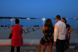 Cannes, France, 13 May 2024: People look out over the Cote d'Azur on the Boulevard de la Croisette