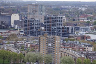 View of urban residential buildings and river with multi-storey buildings under a cloudy sky, view