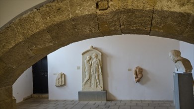 Tomb stele, Krito and Timarista, An exhibition space with ancient stone sculptures and a large