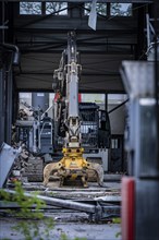 An excavator in a building carrying out construction and demolition work, Demolition, Saarbruecken,