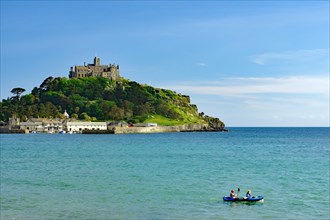 Small boat in front of an island, garden and small harbour, Saint Michael's Mount, Penzance,
