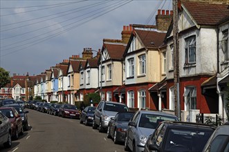 Typical English terraced houses with telephone lines, Ashvale Road, Tooting Broadway, London,