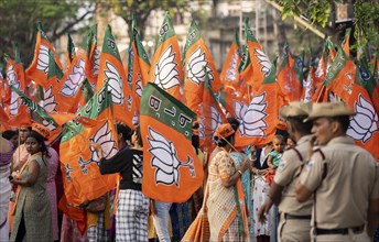 Bharatiya Janata Party (BJP) supporters holding BJP flags arrives to to see a roadshow of Union